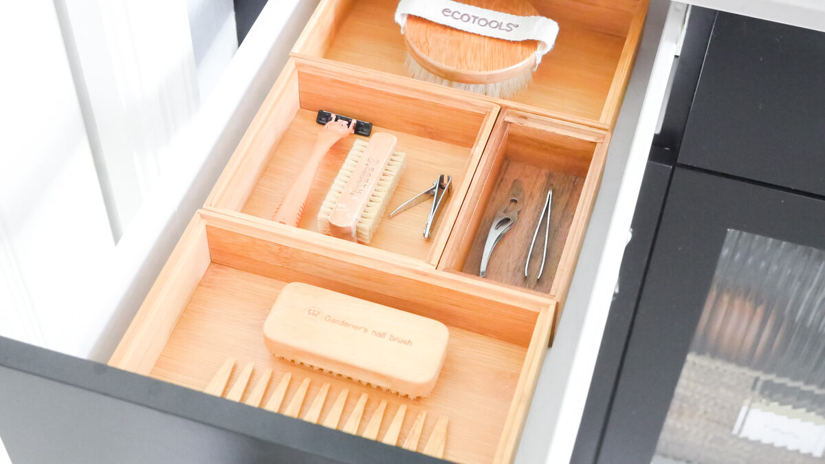 Bathroom vanity drawer with toiletries sorted into sensory-conscious labeled compartments — Simply Spacial Sarasota