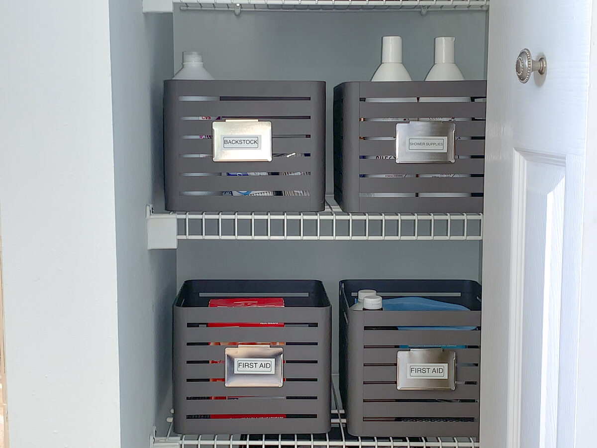 Linen closet with folded towels, labeled baskets, and ADHD-friendly shelf dividers — Simply Spacial in-home organizing, Venice FL