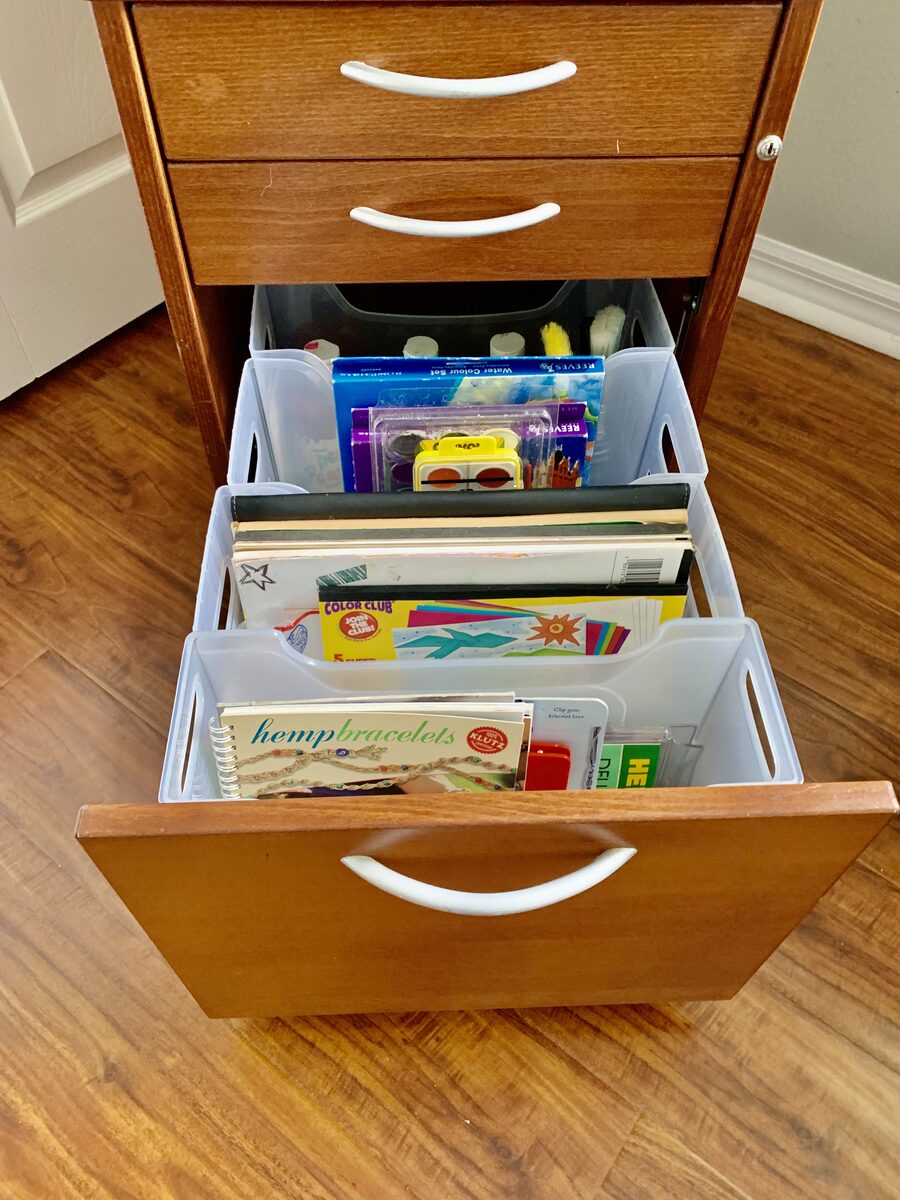 Art and hobby supply cabinet with color-coded containers and clear visibility — Simply Spacial in-home organizer, Sarasota FL